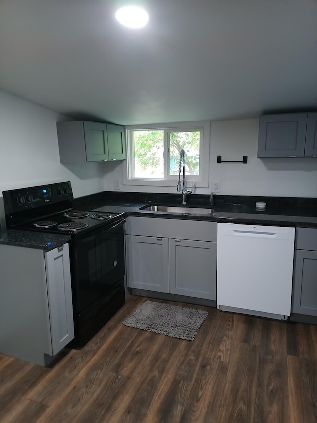 126 7th St, Lancaster, OH 43130 - kitchen with dishwasher, black range with electric cooktop, a sink, dark countertops, and dark wood-style flooring