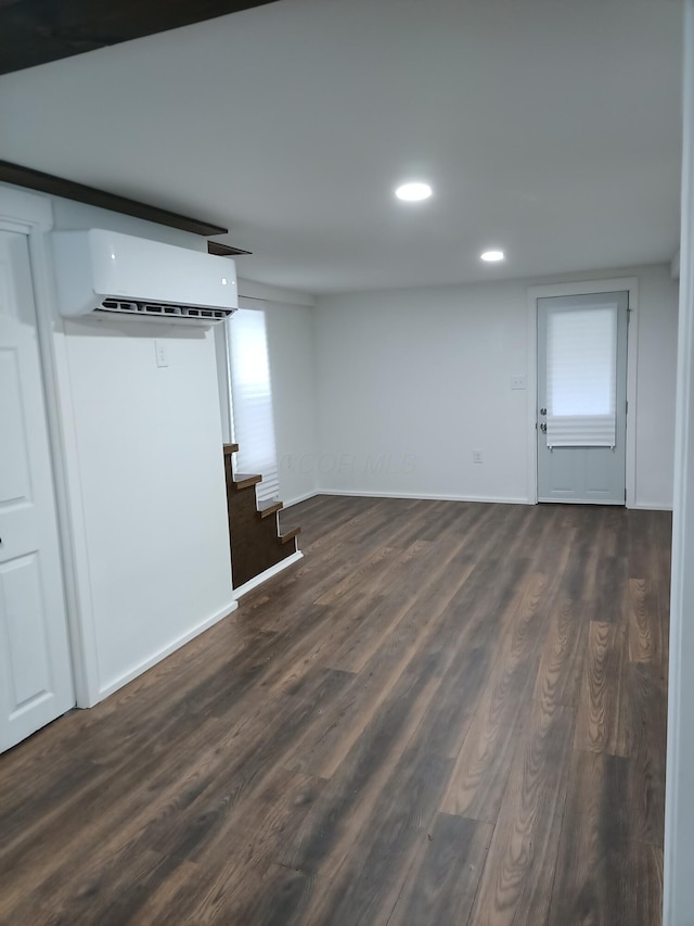 126 7th St, Lancaster, OH 43130 - basement with a wall mounted air conditioner, dark wood-type flooring, stairs, recessed lighting, and baseboards