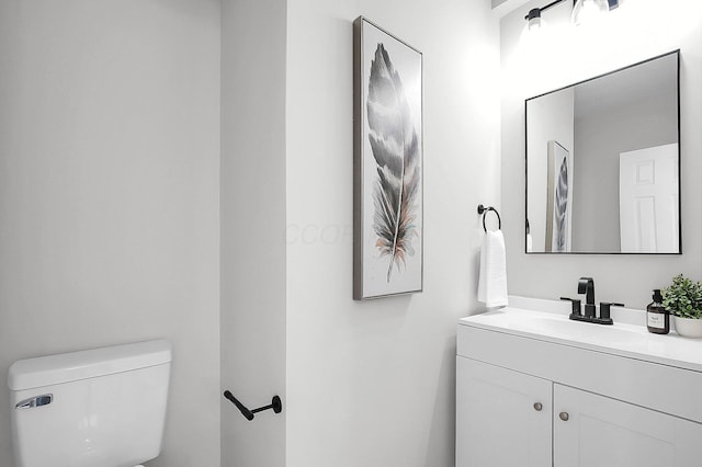 bathroom with toilet and vanity