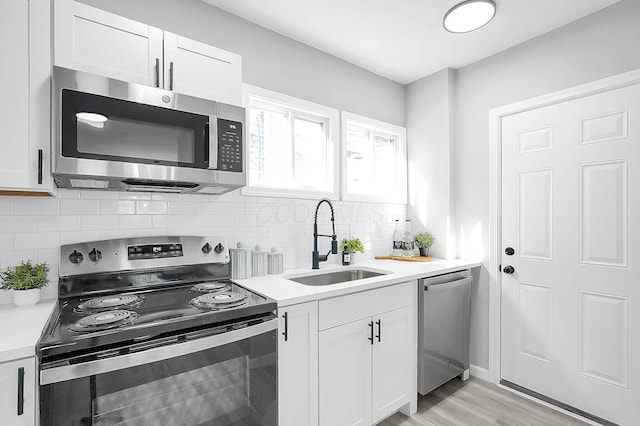 kitchen featuring white cabinets, a sink, and appliances with stainless steel finishes