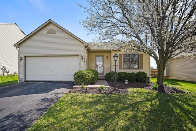 ranch-style house with aphalt driveway, a garage, and a front yard