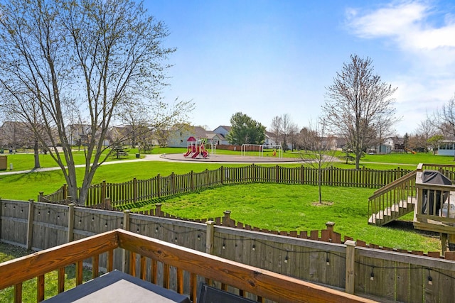 view of yard with a fenced backyard and a playground