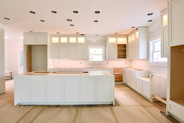 3597 Country Club Rd SW, Lancaster, OH 43130 - kitchen with plenty of natural light, a kitchen island, white cabinets, glass insert cabinets, and recessed lighting