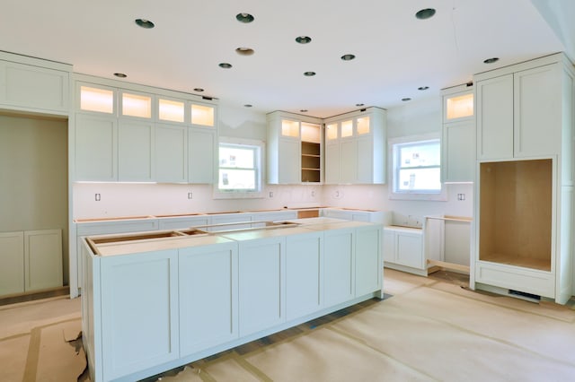 3597 Country Club Rd SW, Lancaster, OH 43130 - kitchen with a center island, plenty of natural light, glass insert cabinets, white cabinetry, and recessed lighting
