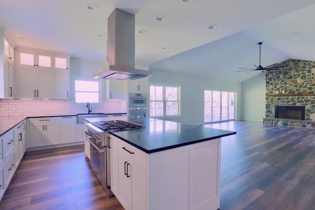 3597 Country Club Rd SW, Lancaster, OH 43130 - kitchen with stainless steel appliances, island exhaust hood, dark countertops, a ceiling fan, and dark wood-style flooring