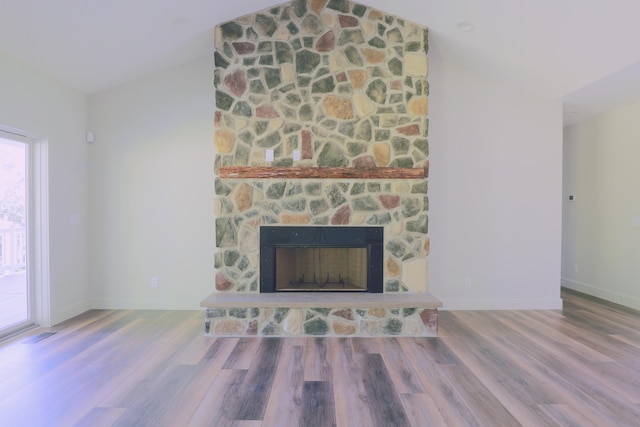 3597 Country Club Rd SW, Lancaster, OH 43130 - unfurnished living room featuring lofted ceiling, wood finished floors, and a stone fireplace