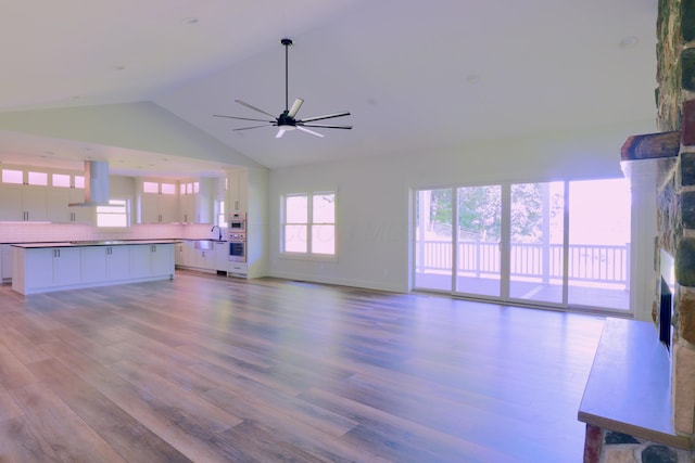 3597 Country Club Rd SW, Lancaster, OH 43130 - unfurnished living room featuring a fireplace, wood finished floors, a ceiling fan, and high vaulted ceiling
