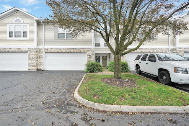 4899 Common Market Pl, Dublin, OH 43016 - multi unit property with stone siding, driveway, and an attached garage