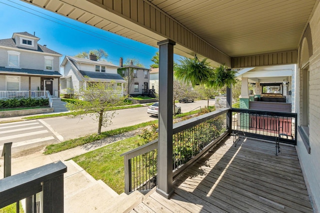 wooden terrace with covered porch and a residential view