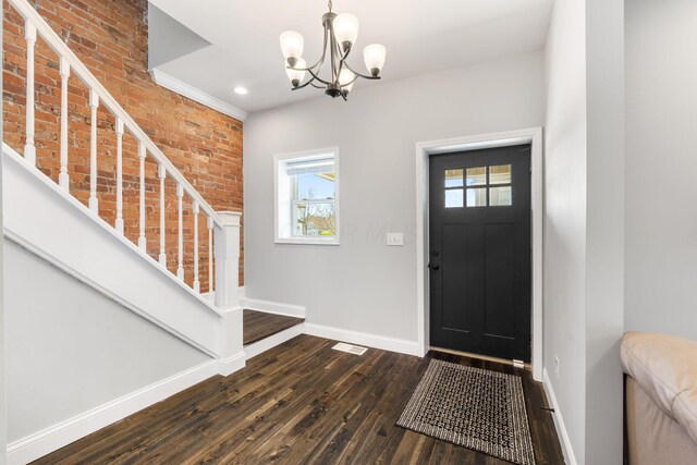 entryway featuring visible vents, an inviting chandelier, dark wood-style flooring, baseboards, and stairway