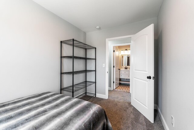 bedroom featuring dark carpet and baseboards