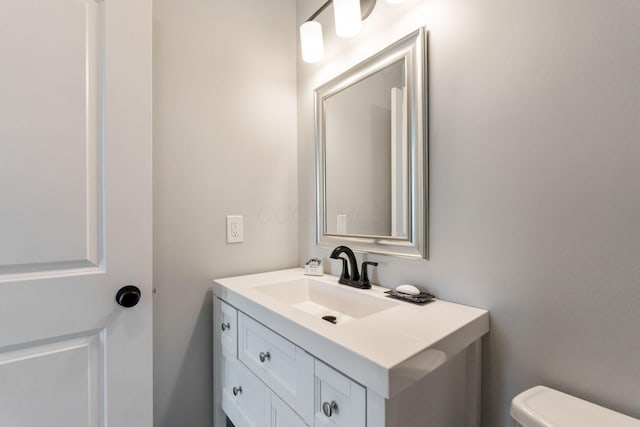 bathroom with toilet and vanity