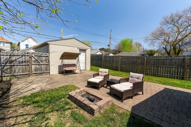 view of yard with an outbuilding, a shed, a fenced backyard, and a patio area