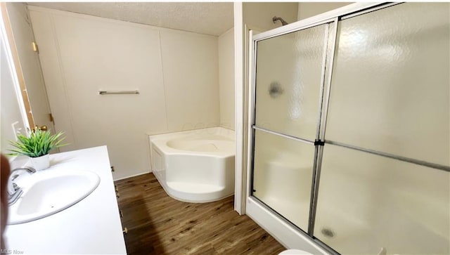 6243 Branch Cir, Zanesville, OH 43701 - bathroom with a bath, a textured ceiling, a shower stall, vanity, and wood finished floors
