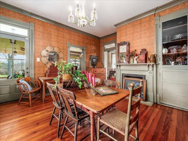 dining room featuring wallpapered walls, a chandelier, and plenty of natural light