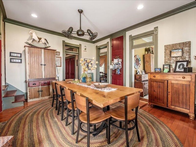 dining space with recessed lighting, dark wood finished floors, stairs, and ornamental molding