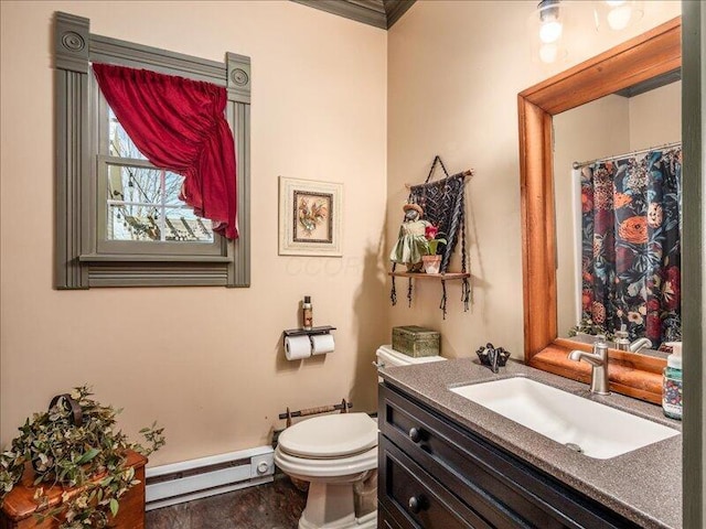 bathroom featuring a baseboard radiator, crown molding, vanity, a shower with curtain, and toilet