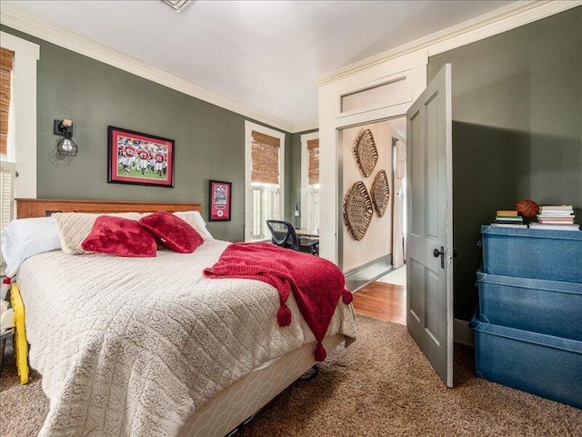 carpeted bedroom featuring crown molding