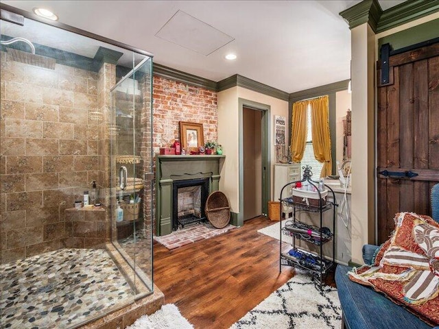 living room featuring recessed lighting, ornamental molding, wood finished floors, and a fireplace