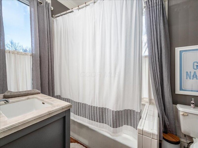 full bath featuring shower / bath combo with shower curtain, toilet, and vanity