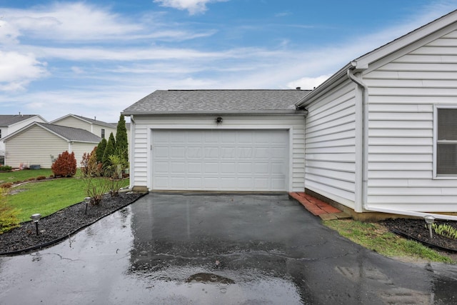 garage featuring aphalt driveway