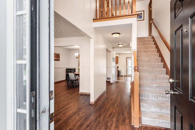 3073 Kola Way, Columbus, OH 43219 - entrance foyer with stairs, dark wood-style flooring, baseboards, and a textured ceiling