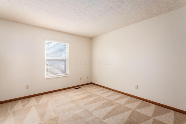 3073 Kola Way, Columbus, OH 43219 - empty room featuring baseboards, visible vents, light colored carpet, and a textured ceiling