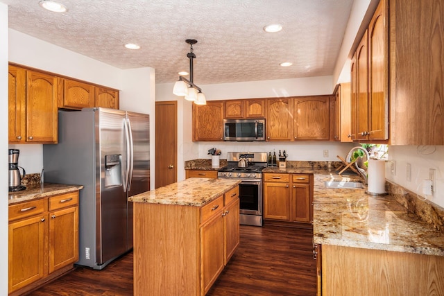 3073 Kola Way, Columbus, OH 43219 - kitchen featuring dark wood-type flooring, appliances with stainless steel finishes, a sink, and a kitchen island
