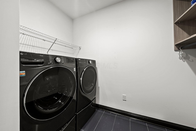 225 John H Mcconnell Blvd Unit 705, Columbus, OH 43215 - laundry area with baseboards, washing machine and dryer, tile patterned flooring, and laundry area