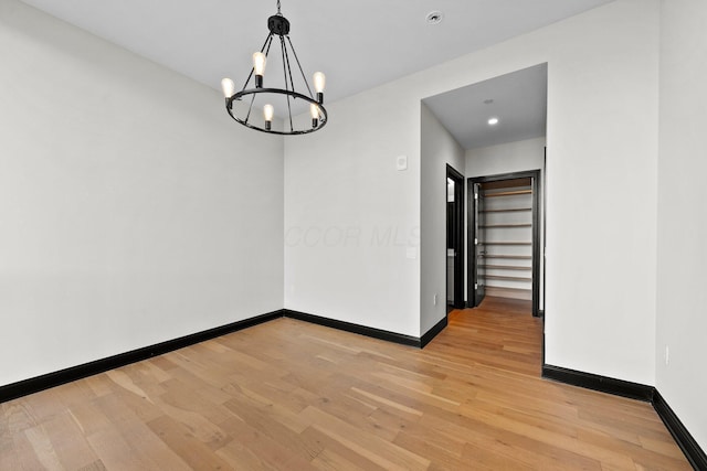 225 John H Mcconnell Blvd Unit 705, Columbus, OH 43215 - unfurnished dining area with light wood-style floors, a notable chandelier, and baseboards
