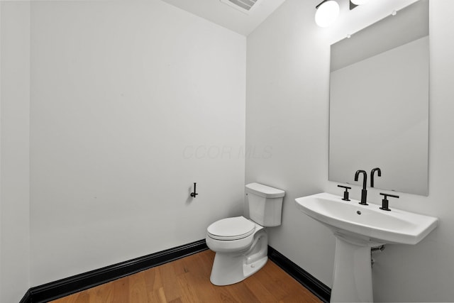 225 John H Mcconnell Blvd Unit 705, Columbus, OH 43215 - bathroom with toilet, wood finished floors, baseboards, and visible vents