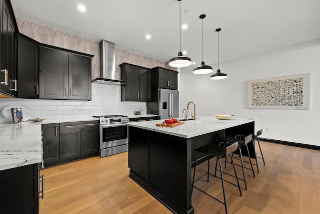 225 John H Mcconnell Blvd Unit 705, Columbus, OH 43215 - kitchen with wall chimney exhaust hood, appliances with stainless steel finishes, a sink, dark cabinetry, and backsplash