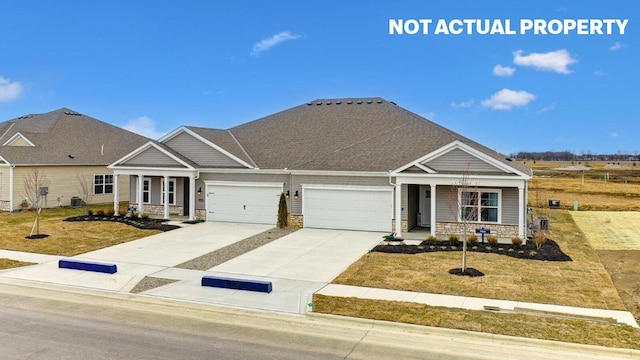 view of front of house featuring a front yard, a porch, and driveway
