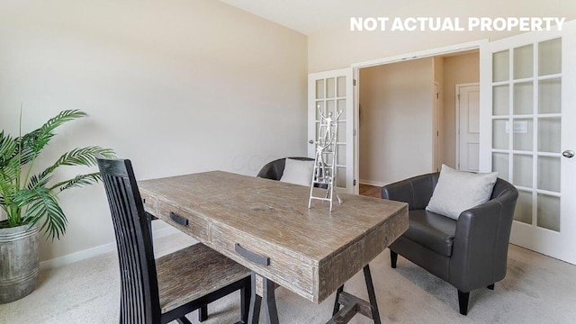 home office featuring french doors, light colored carpet, and baseboards