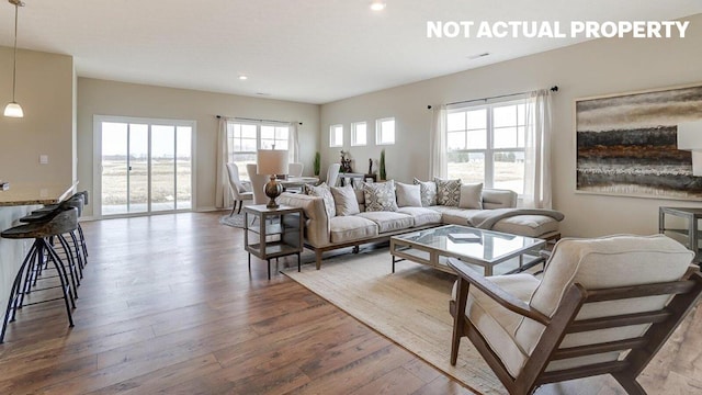 living area with recessed lighting and wood-type flooring