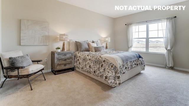 bedroom featuring light carpet and baseboards