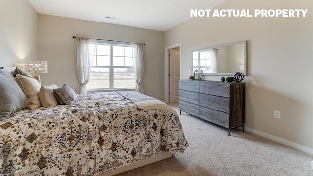 bedroom featuring visible vents, baseboards, multiple windows, and light colored carpet