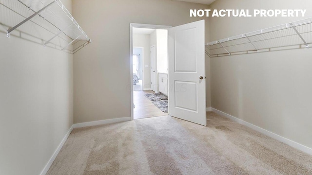 spacious closet with carpet floors