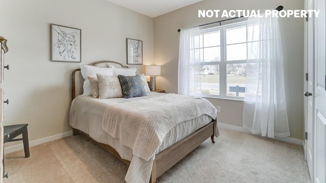 bedroom featuring light colored carpet and baseboards