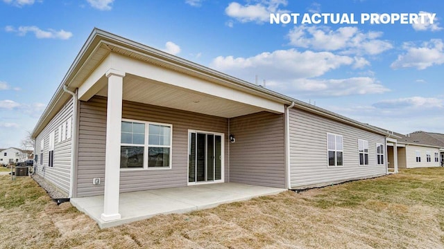 rear view of property with a patio and a lawn