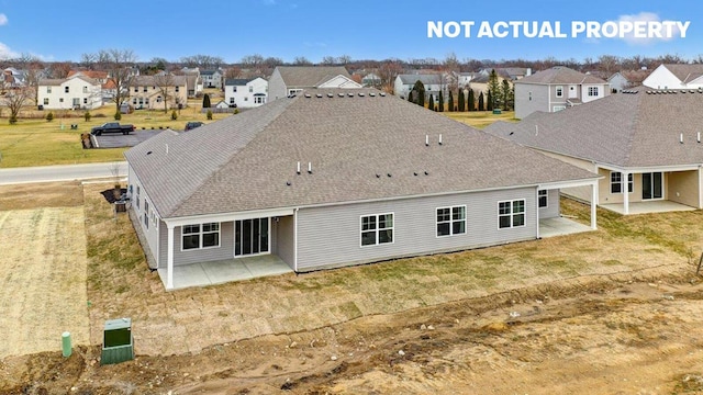 back of property featuring a residential view, a patio, a lawn, and roof with shingles