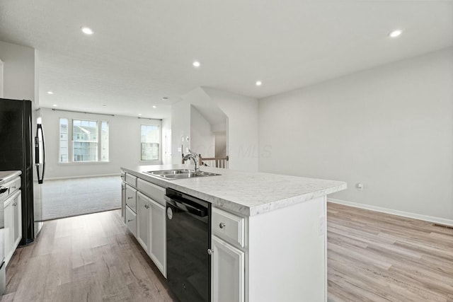 858 Blackcomb Dr, Cincinnati, OH 45244 - kitchen featuring an island with sink, dishwasher, light wood-type flooring, and a sink