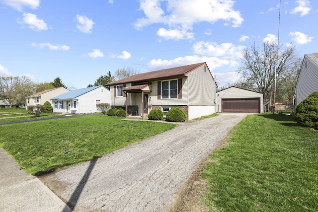 split foyer home with a front yard, a detached garage, and an outdoor structure