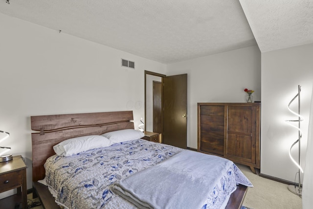 bedroom featuring visible vents, baseboards, carpet floors, and a textured ceiling