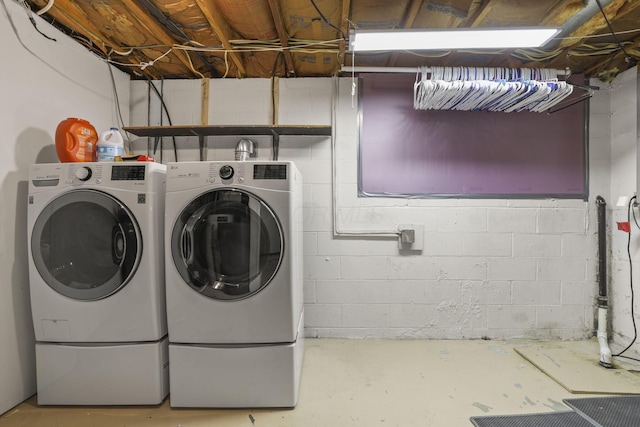 washroom with washing machine and clothes dryer and laundry area