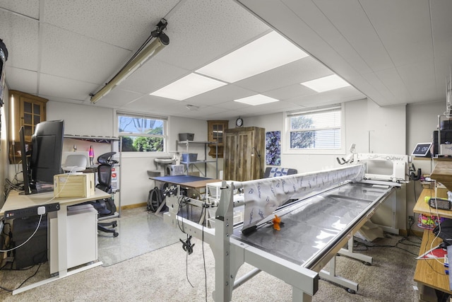 office featuring a drop ceiling and baseboards