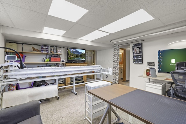 carpeted office space featuring a drop ceiling