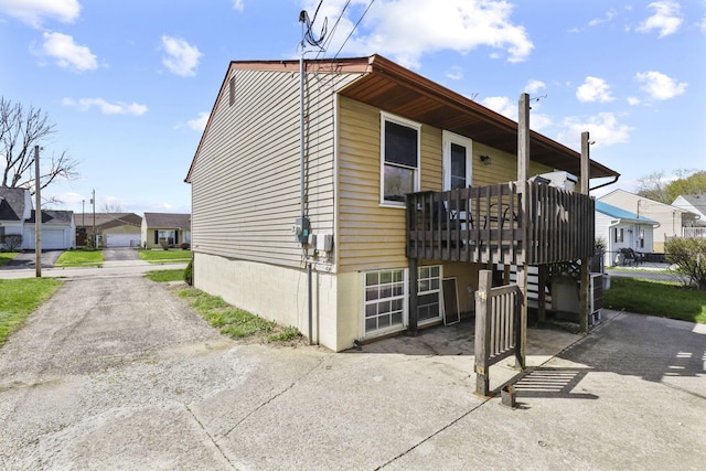 view of side of property featuring fence and a residential view