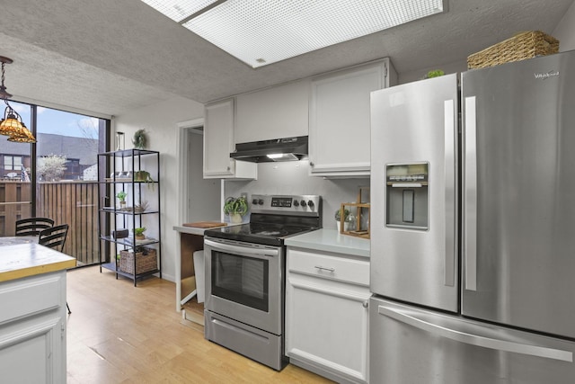 kitchen featuring white cabinets, under cabinet range hood, and stainless steel appliances