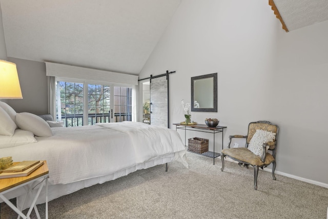bedroom featuring high vaulted ceiling, baseboards, a barn door, and carpet floors